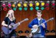 A group of people playing instruments

Description automatically generated