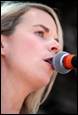 A person singing into a microphone

Description automatically generated