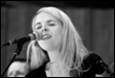 A person singing into a microphone

Description automatically generated