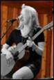 A person playing guitar and singing

Description automatically generated