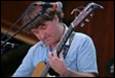 A person playing a guitar

Description automatically generated