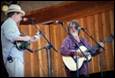A couple of people playing instruments

Description automatically generated