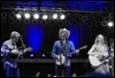 A group of people playing instruments on a stage

Description automatically generated