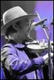 A person wearing a cowboy hat and playing a violin

Description automatically generated