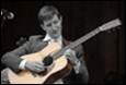 A person playing a guitar

Description automatically generated