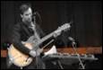 A person playing a guitar

Description automatically generated