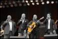 A group of men playing instruments

Description automatically generated