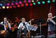 A group of people playing instruments

Description automatically generated