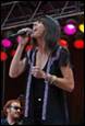 A person singing into a microphone

Description automatically generated