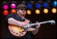 A person playing a guitar

Description automatically generated