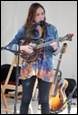 A person playing a guitar

Description automatically generated