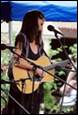 A person playing guitar on stage

Description automatically generated