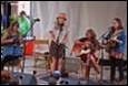 A group of people playing instruments

Description automatically generated