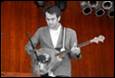 A person playing a guitar

Description automatically generated