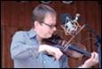 A person playing a violin

Description automatically generated