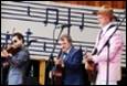 A group of people playing instruments

Description automatically generated