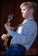 A person playing a guitar

Description automatically generated
