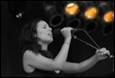 A person singing into a microphone

Description automatically generated