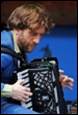 A person holding an accordion

Description automatically generated