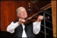 A person playing a violin

Description automatically generated