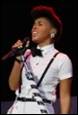 A person singing into a microphone

Description automatically generated