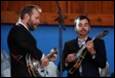 A group of men playing instruments

Description automatically generated