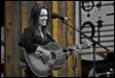 A person playing a guitar

Description automatically generated