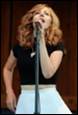 A person singing into a microphone

Description automatically generated
