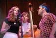 A group of people singing and playing instruments

Description automatically generated
