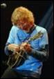 A person playing a guitar

Description automatically generated
