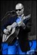 A person playing a guitar

Description automatically generated