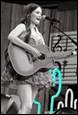 A person holding a guitar

Description automatically generated