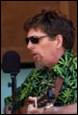 A person wearing sunglasses and a green shirt

Description automatically generated