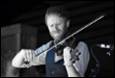 A person playing a violin

Description automatically generated