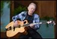 A person playing a guitar

Description automatically generated