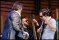 A group of men playing instruments

Description automatically generated