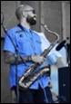 A person playing a saxophone

Description automatically generated