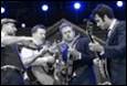 A group of men playing instruments

Description automatically generated