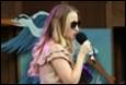 A person holding a microphone

Description automatically generated