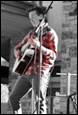 A person playing a guitar

Description automatically generated