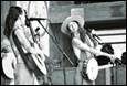 A person playing instruments and a person playing instruments

Description automatically generated