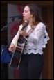 A person singing into a microphone

Description automatically generated