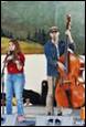 A person and person playing instruments

Description automatically generated