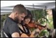 A group of people playing instruments

Description automatically generated