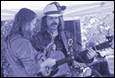 A group of men playing guitars

Description automatically generated