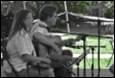 A person and person playing instruments

Description automatically generated