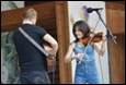 A person and person playing instruments

Description automatically generated