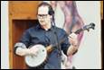 A person playing a banjo

Description automatically generated