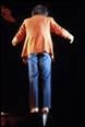 A person in a red shirt and blue jeans

Description automatically generated