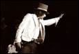 A person in a hat and suit holding a guitar

Description automatically generated with low confidence